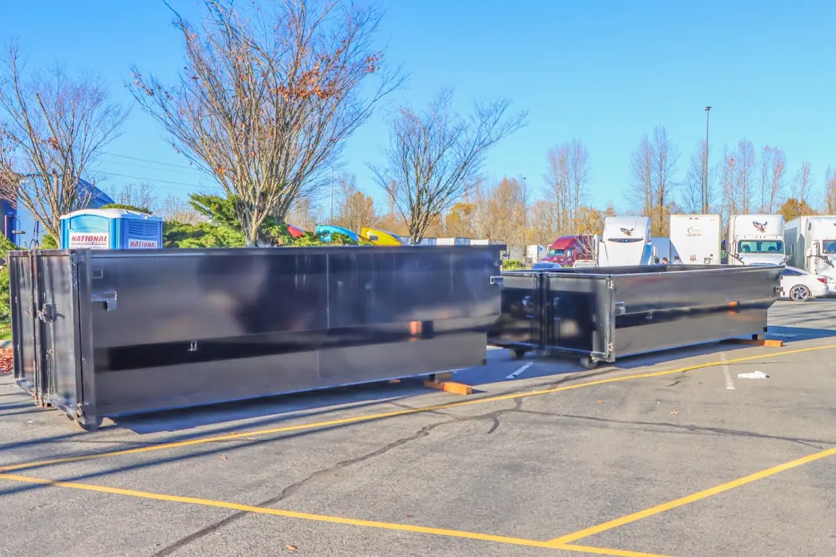 Professional dumpster rental service with roll-off container on residential driveway in Royal Palm Beach